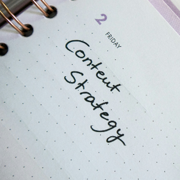 Desk with a planner with the words Content Strategy on it