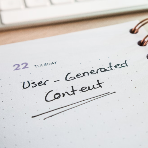 Desk with a planner with the words User-Generated Content on it