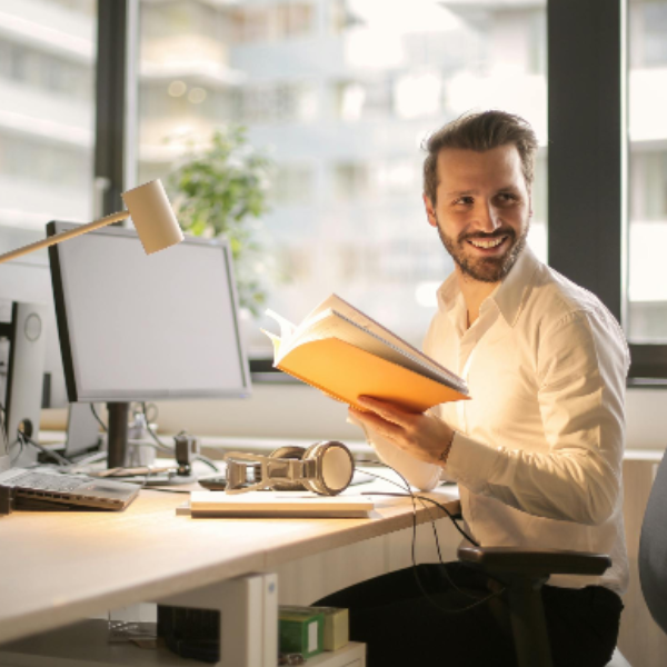 Photo of Man Holding a Book